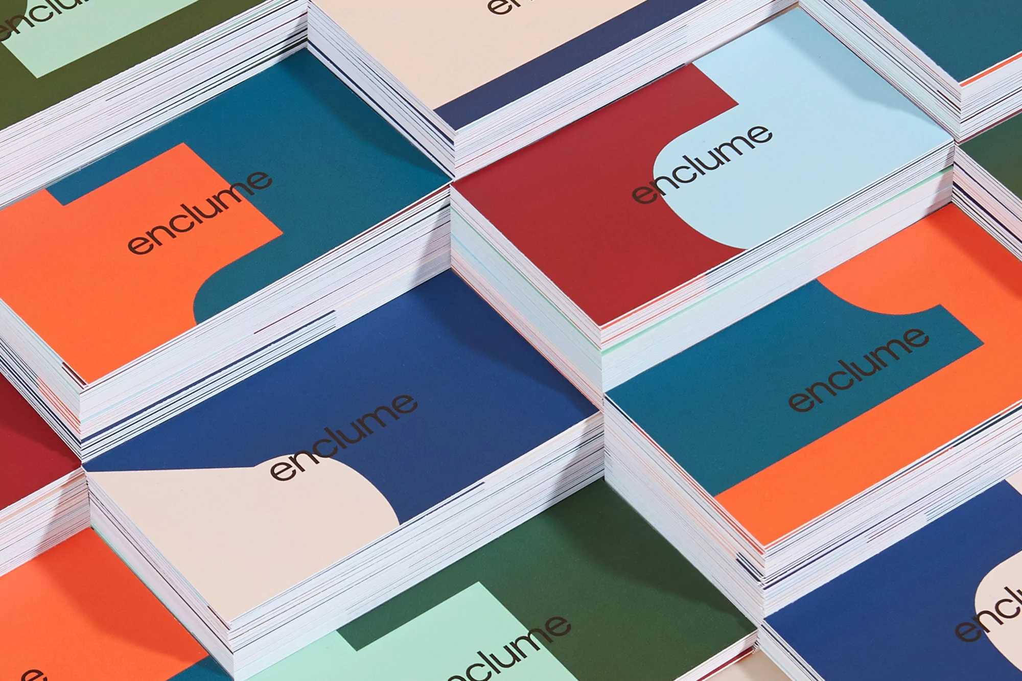 Stacks of colorful, uniquely designed business cards arranged in a visually appealing pattern, showcasing modern graphic design.