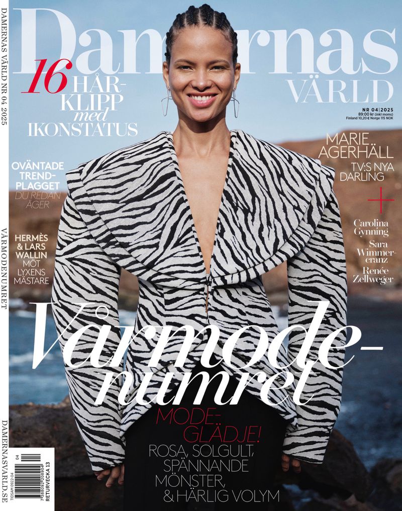 Magazine cover featuring a smiling woman in a black-and-white patterned jacket, with editorial text, against an outdoor background.