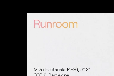 Runroom brand identity typography printed on textured white paper stationery against black