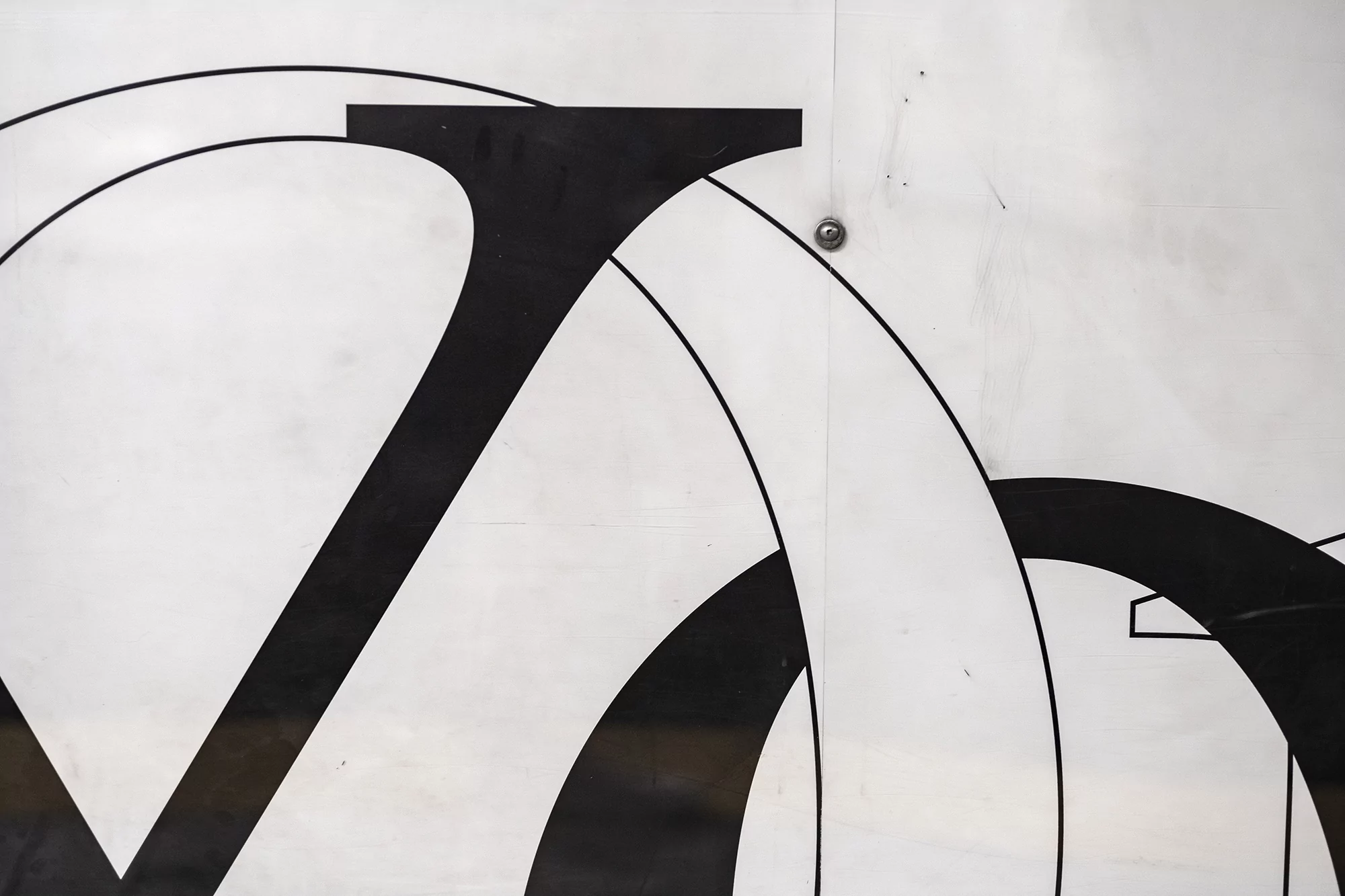 Abstract close-up of white surface with black geometric shapes and lines, creating a bold and modern design element.