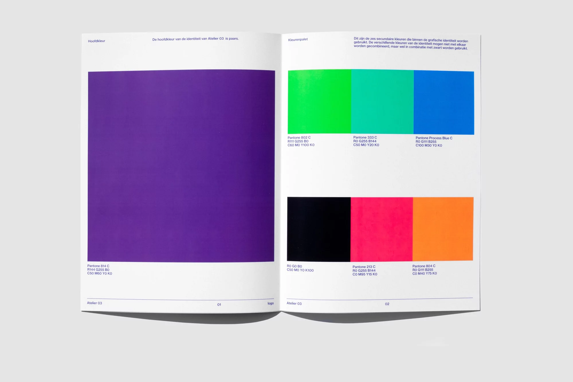 Open book showcasing colorful design swatches with Pantone references on white pages, shot in bright, even lighting.