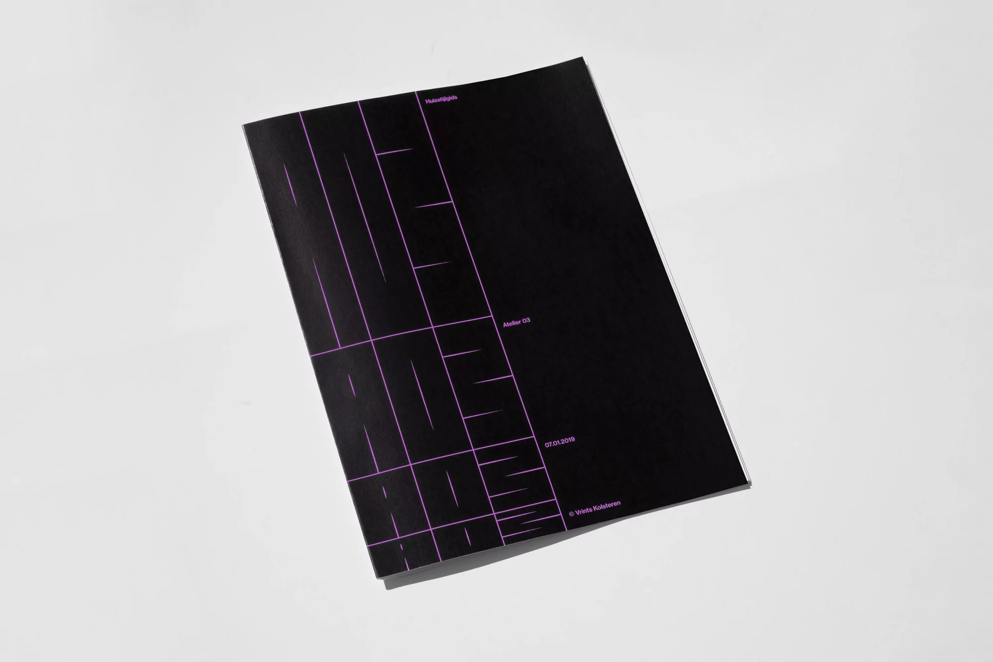 Black booklet with purple geometric design cover on a white background, showcasing minimalist graphic design and a modern aesthetic.