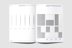 An open brand identity guidelines booklet displaying grid layouts and vertical alignment lines on clean white pages.