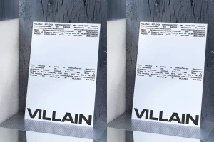 Printed receipt with Villain Studio branding and typography displayed against a textured dark surface