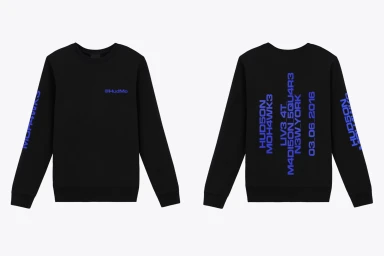Front and back views of a black crewneck sweatshirt featuring blue typographic branding and text against a plain white background.