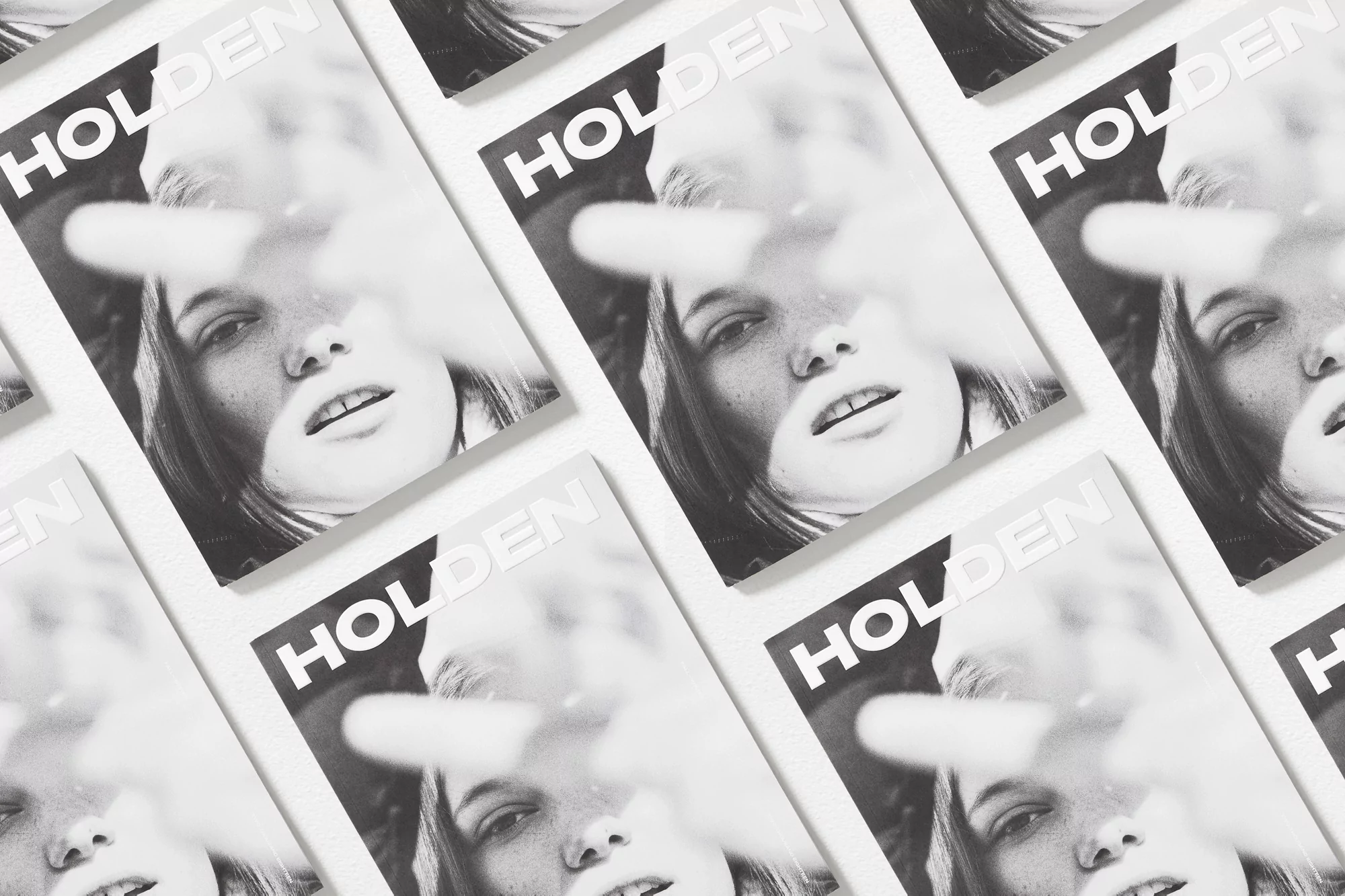 Multiple magazine covers featuring a black-and-white portrait of a young woman partially obscured by bright, diffused light.