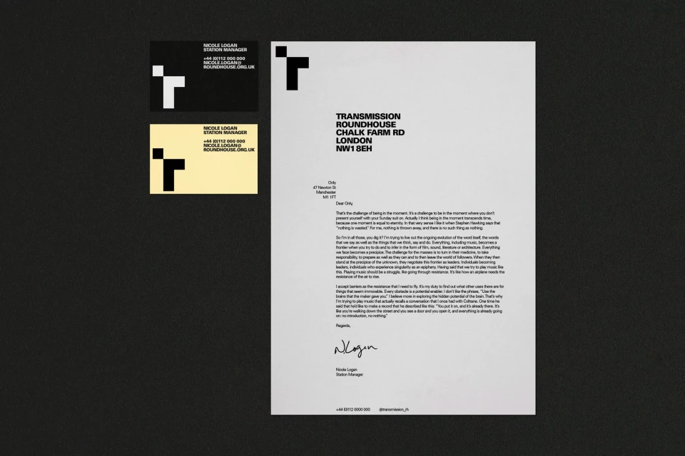 Letterhead and business cards showcase a minimalist design with a modern logo on white and black paper, emphasizing brand identity.