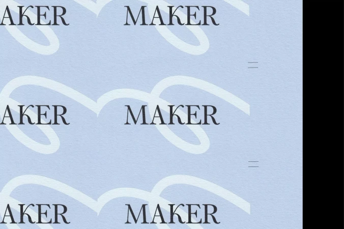 Close-up shot of the word 'MAKER' printed multiple times in a repetitive pattern on light blue paper, design with text.