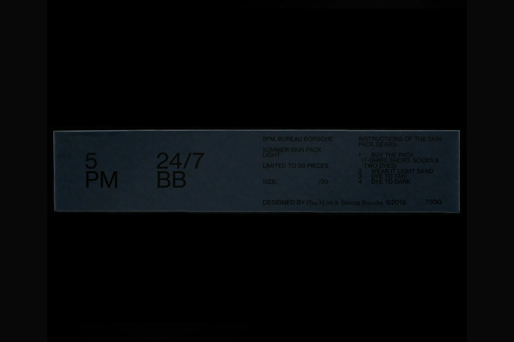 Dark gray box with '5 PM' and '24/7 BB' printed on it, along with other brand and product information text on a dark background.