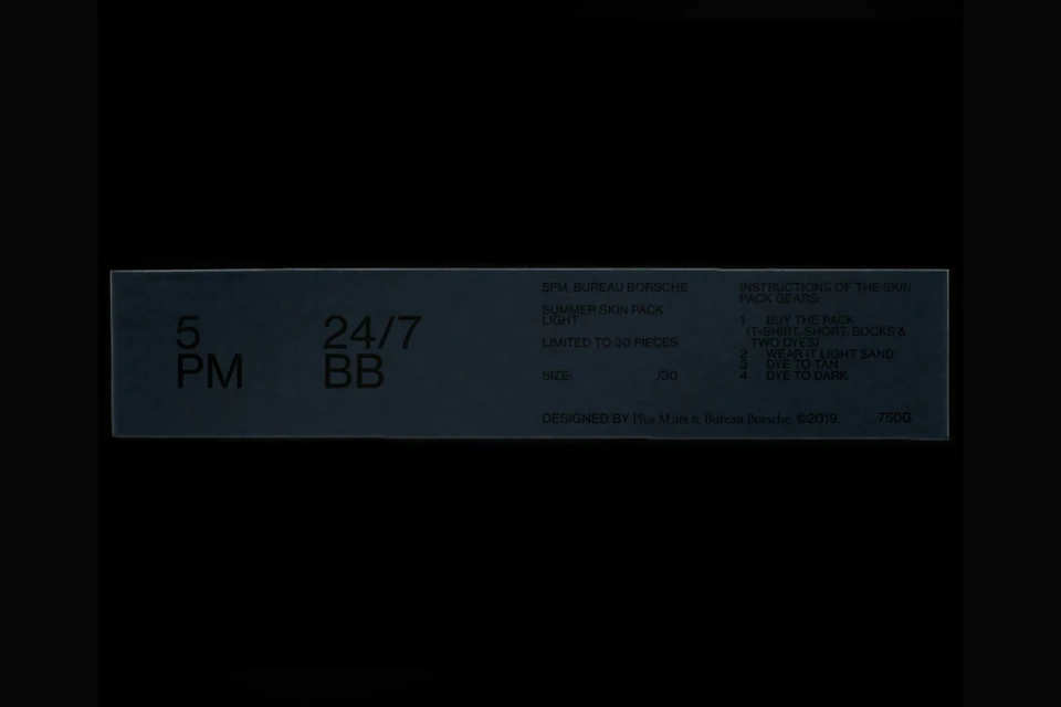 Dark gray box with '5 PM' and '24/7 BB' printed on it, along with other brand and product information text on a dark background.
