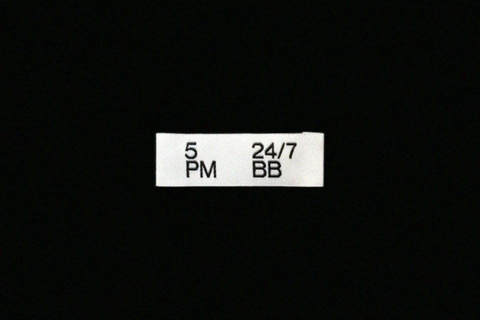 Text label on a black background displaying '5 PM' and '24/7 BB', indicating a time or service availability.