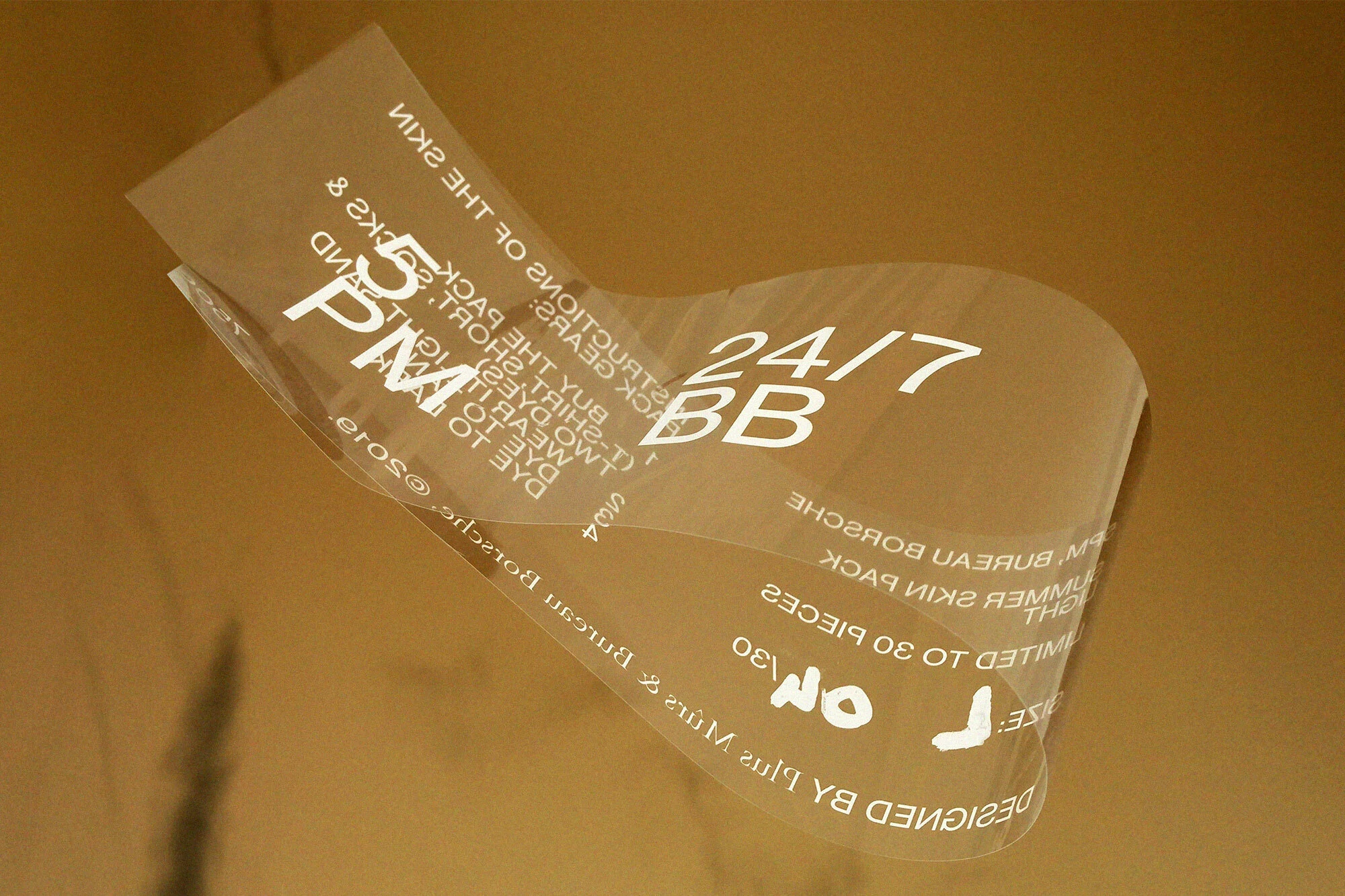Clear wrapping with text on a gold background. Product package with instructions for skin application. Beauty and personal care theme.