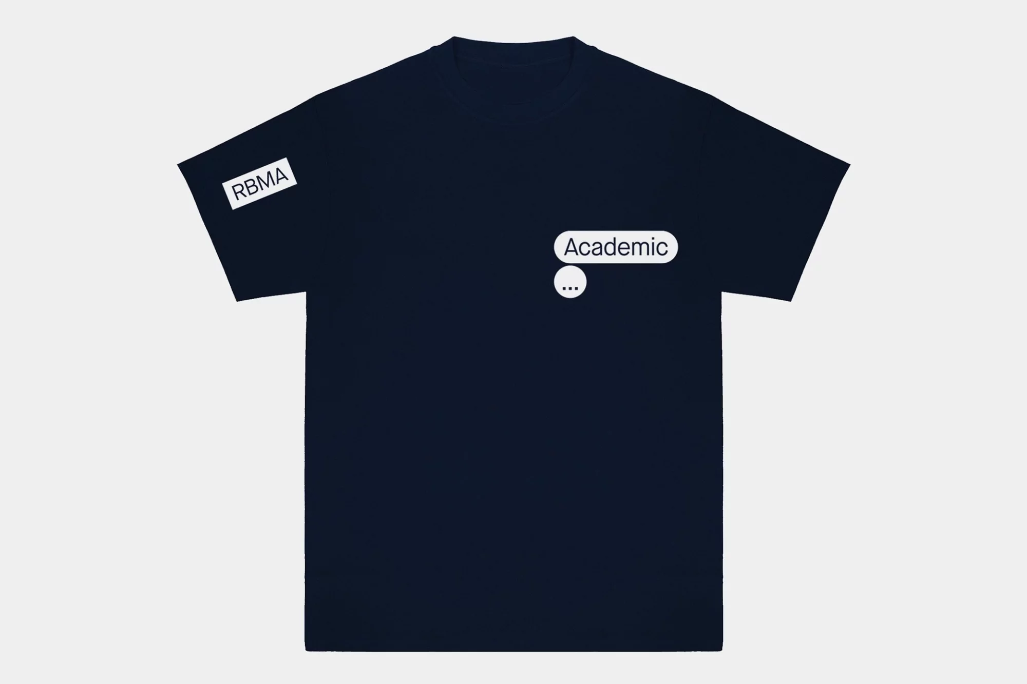 Dark blue t-shirt on a white surface with the text “Academic” and a message bubble printed on the front and RBMA on the sleeve.