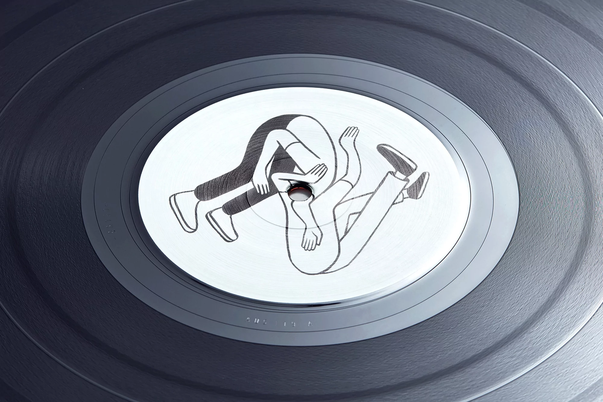 Vinyl record featuring an illustration of two figures in black and white, arms outstretched, legs positioned at opposing angles.