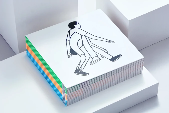 Stack of white square notebooks with a line-art illustration of a person on top and colorful spine accents.