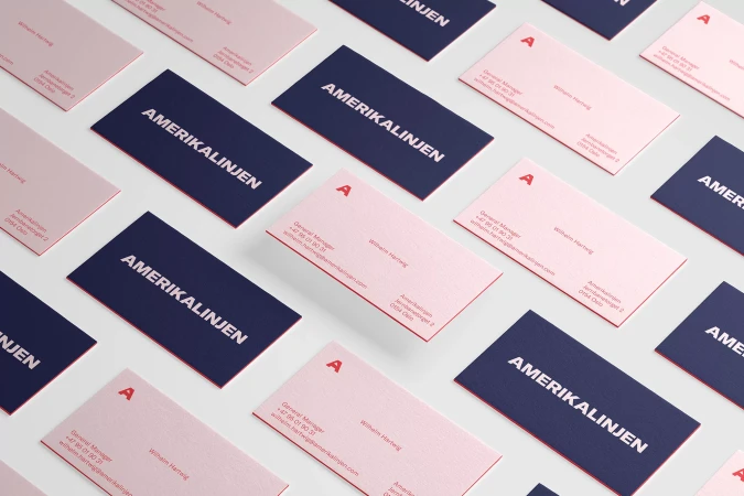 Scattered business cards in pink and navy blue with company logo and contact details. Clean product shot for branding and marketing.