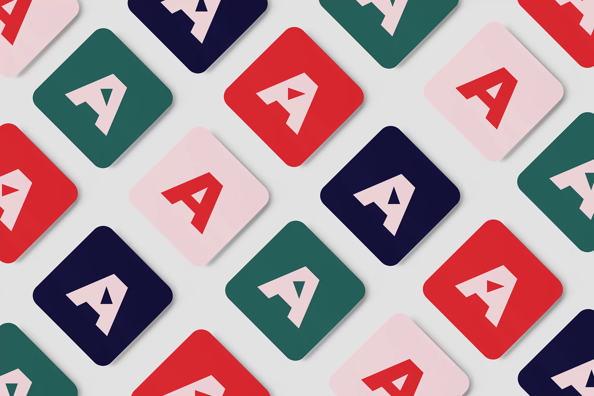 Colorful geometric pattern featuring rounded square icons with the letter A in white on a background of red, green, blue, and pink.