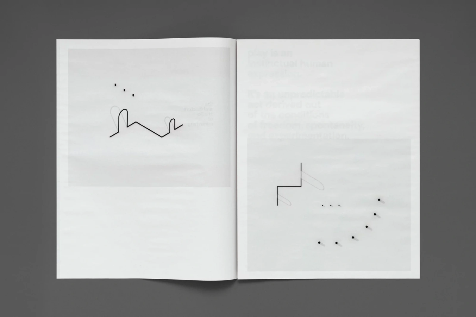 Open book spread showing minimalist black line drawings and dot patterns on white pages against a dark grey background.