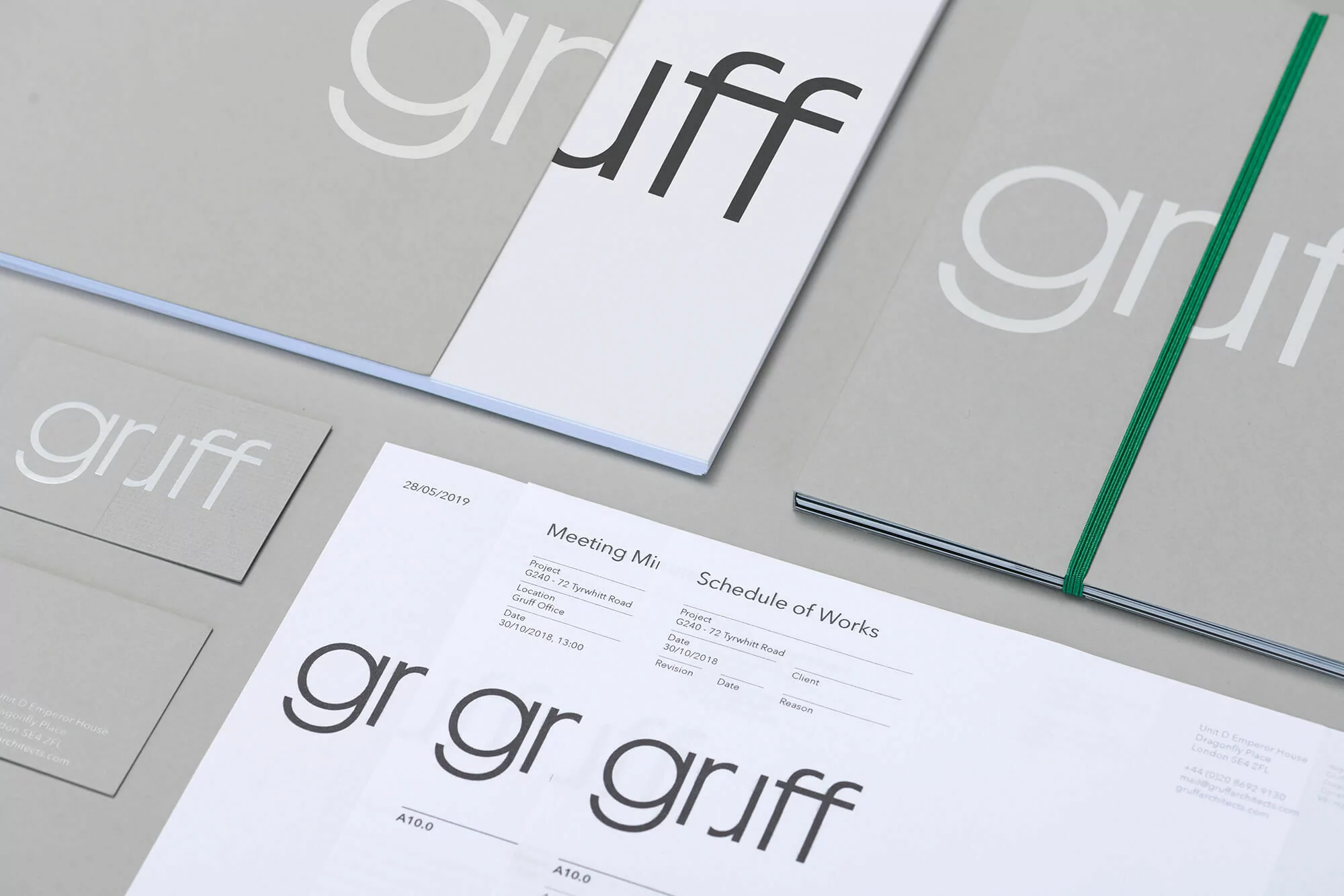 Stationery branding featuring the word 'gruff' on documents and business cards with a clean, minimalist design in gray and white tones.