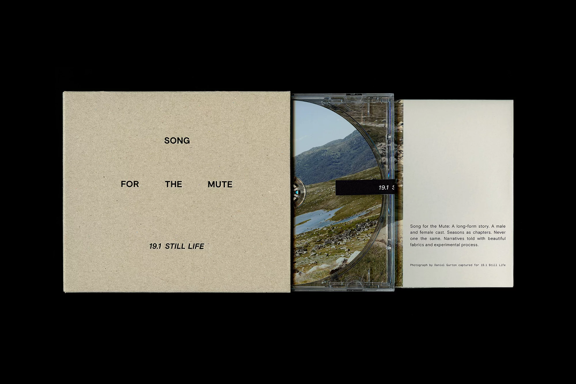 Opened beige CD case featuring the text 'Song for the Mute' and a CD with an image of a mountain landscape on a black backdrop.