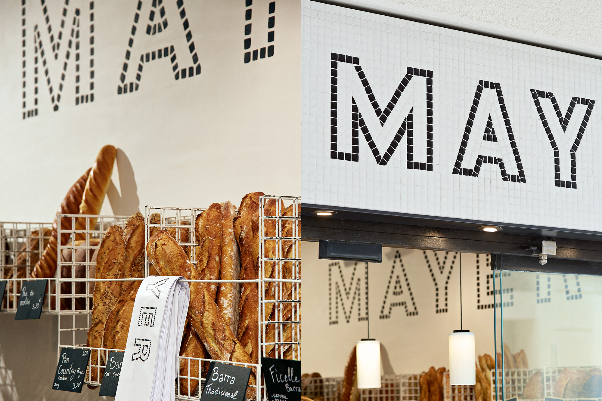 Close-up of a bakery interior, showcasing wire baskets filled with baguettes and bread, and the bakery's name "MAY" in tiled mosaic.