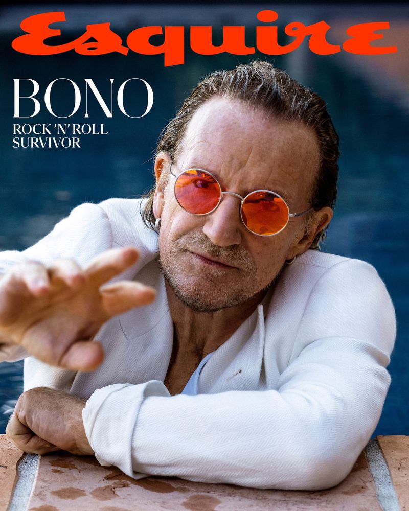Esquire cover featuring Bono with rose-tinted glasses in white suit against blue pool, hand extended, 'Esquire' and title text visible.