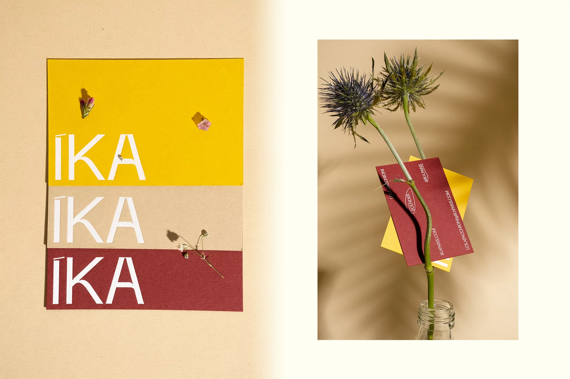 Still life of business cards with 'IKA' text next to flowers in a vase, set against a solid beige background and soft lighting.