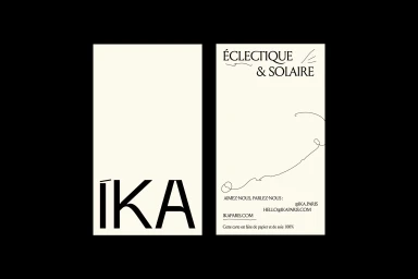 Two cream-coloured minimalist business cards with black typography and continuous line art for brand IKA.
