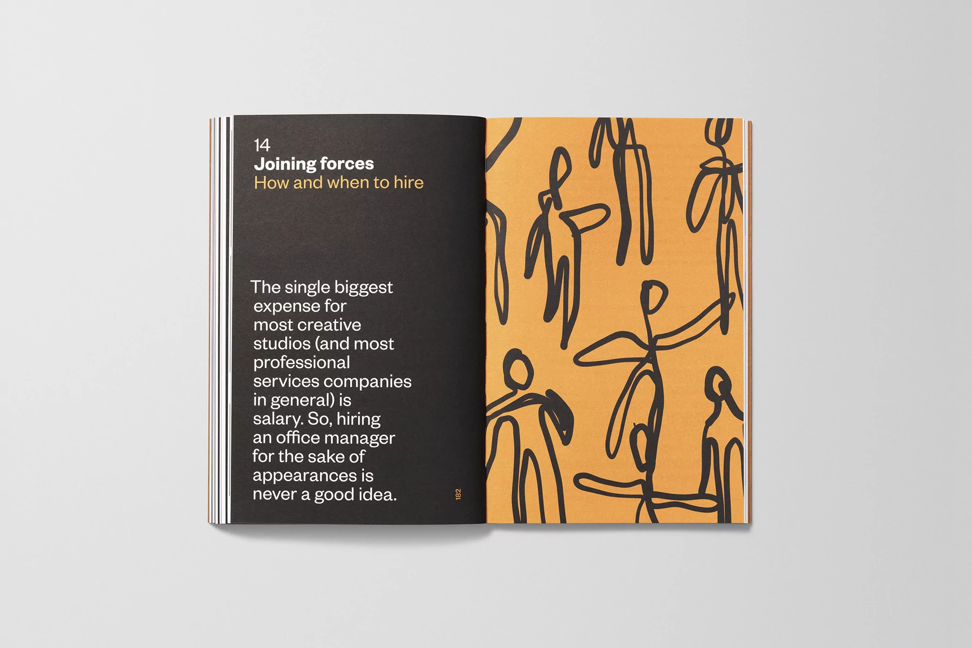 Open book lies flat, featuring abstract figures on orange page with text on black. Academic or business publication concept.