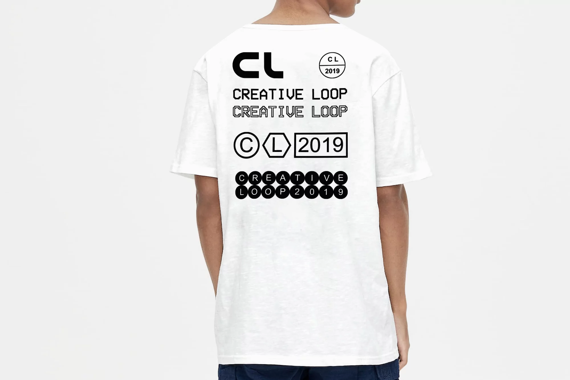 Back view of a person wearing a white T-shirt with black Creative Loop text and graphic logos on the upper back.