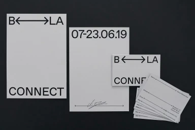 B-LA Connect brand identity collateral items including posters and business cards arranged on a dark surface.