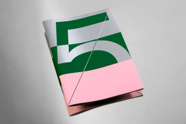 Folded brochure featuring a bold green and pink geometric graphic design on a neutral grey background.