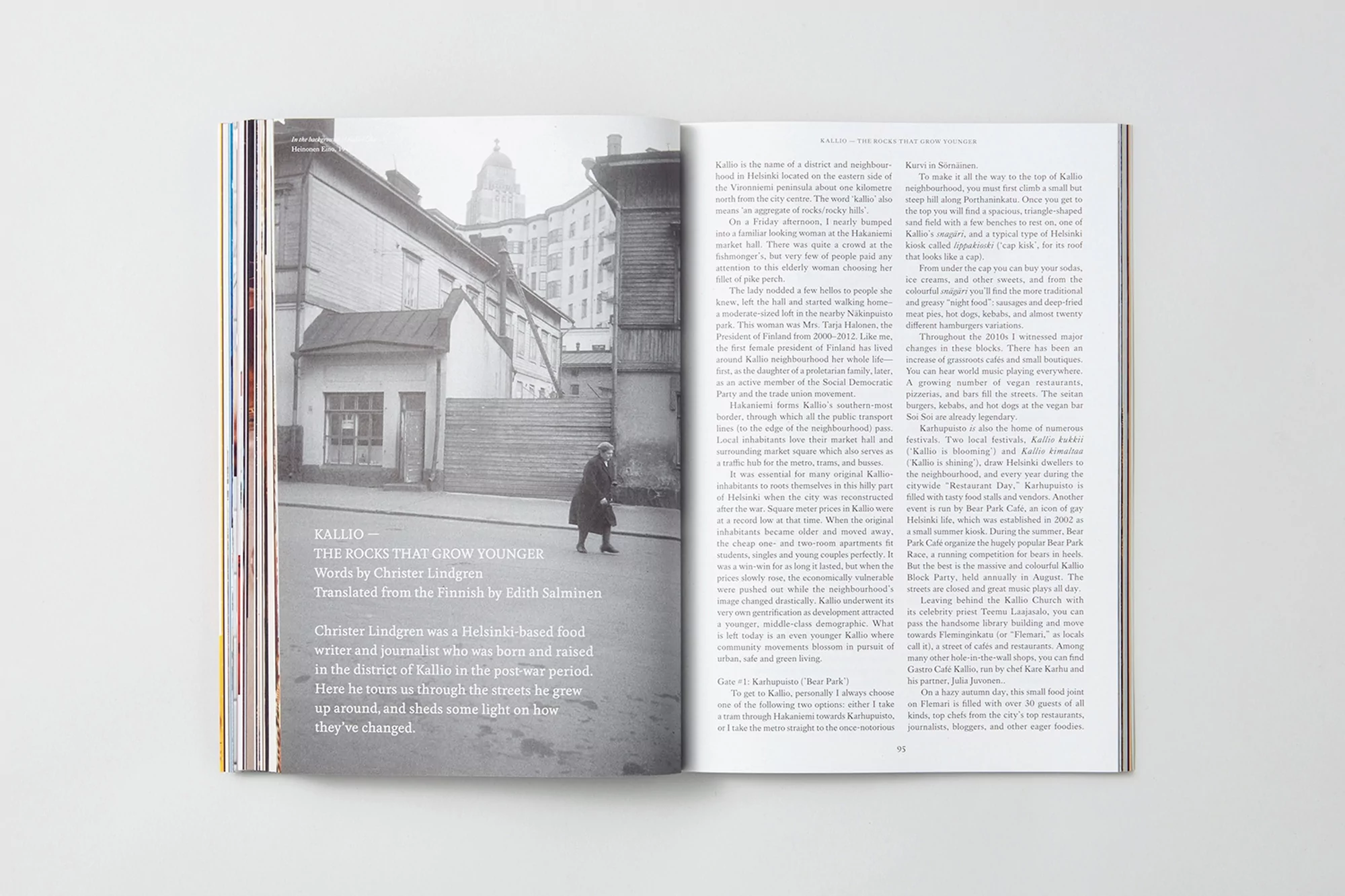 Open magazine spread showing a black and white photograph of a city street on the left and columns of text on the right