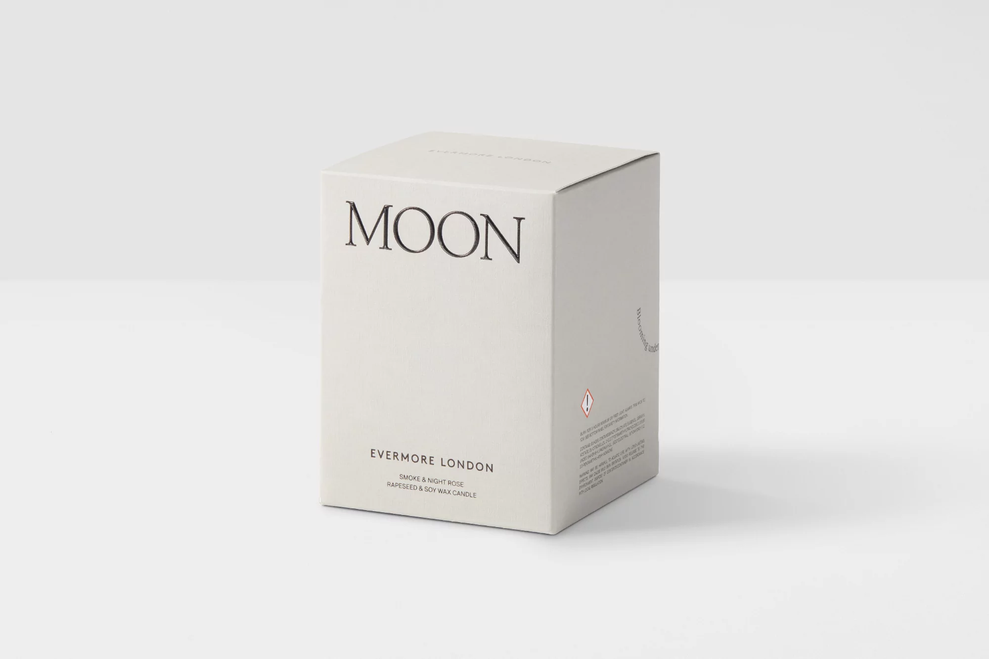 Close-up of a white square box for an Evermore London Moon scented candle. The box features black minimalist text branding.