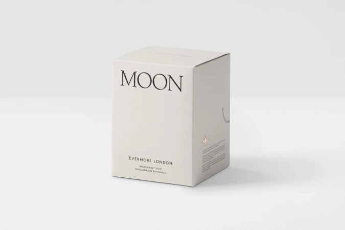 Close-up of a white square box for an Evermore London Moon scented candle. The box features black minimalist text branding.