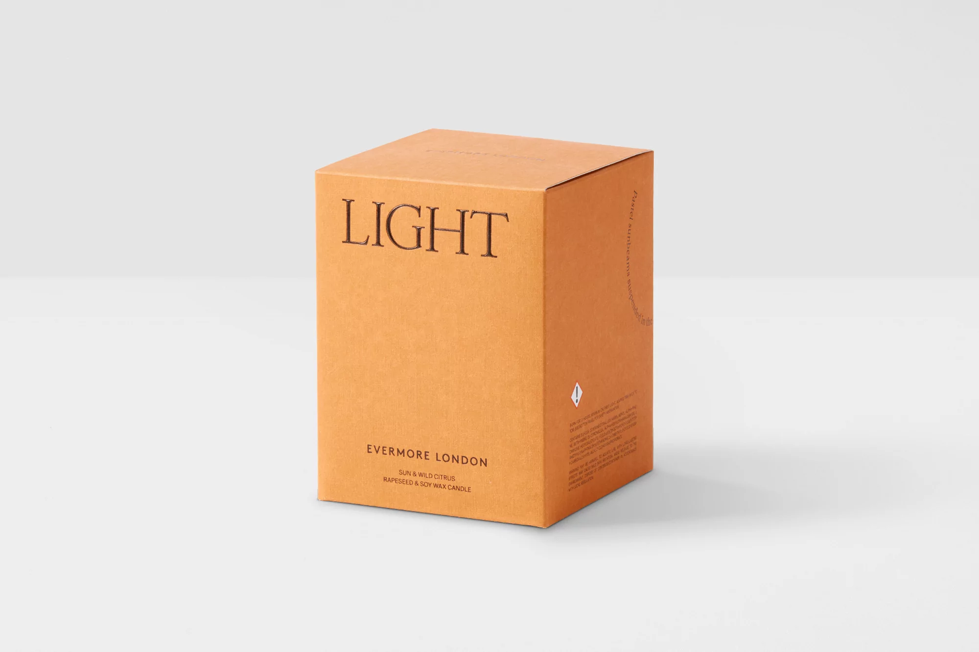 Product shot of an Evermore London 'Light' scented candle in its orange box, displayed against a clean white background.