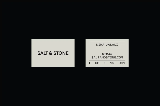 Two business cards with 'Salt & Stone' branding on a dark background, featuring contact details and a clean, minimalist design.