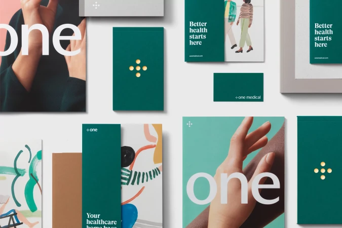 Healthcare marketing materials featuring illustrated promotional art and printed collateral on a white surface, emphasizing modern design elements.