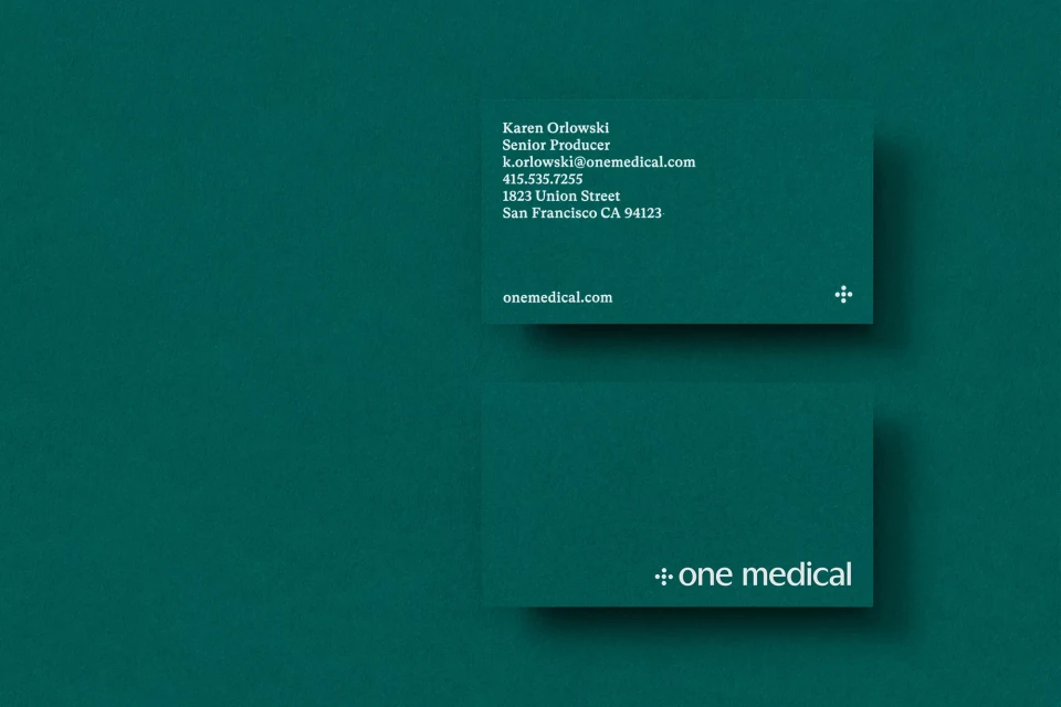Two business cards with text for Karen Orlowski, Senior Producer, on top of a green-colored background. Brand logo visible on both cards.