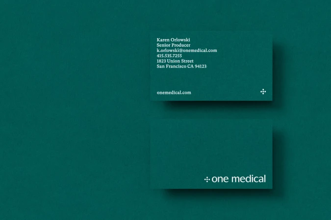 Two business cards with text for Karen Orlowski, Senior Producer, on top of a green-colored background. Brand logo visible on both cards.