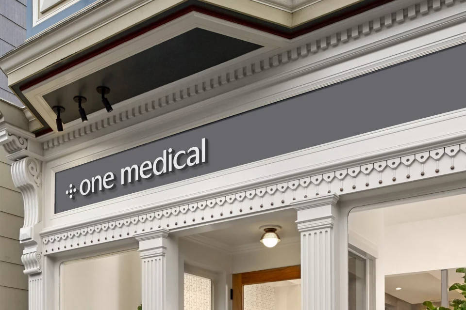 Exterior shot of a modern building with a 'one medical' sign above the entrance, featuring white architectural details.