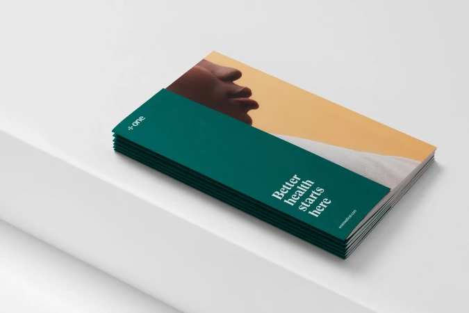 Stack of promotional pamphlets for health services with focus on branding, health, and business messaging in a modern design.