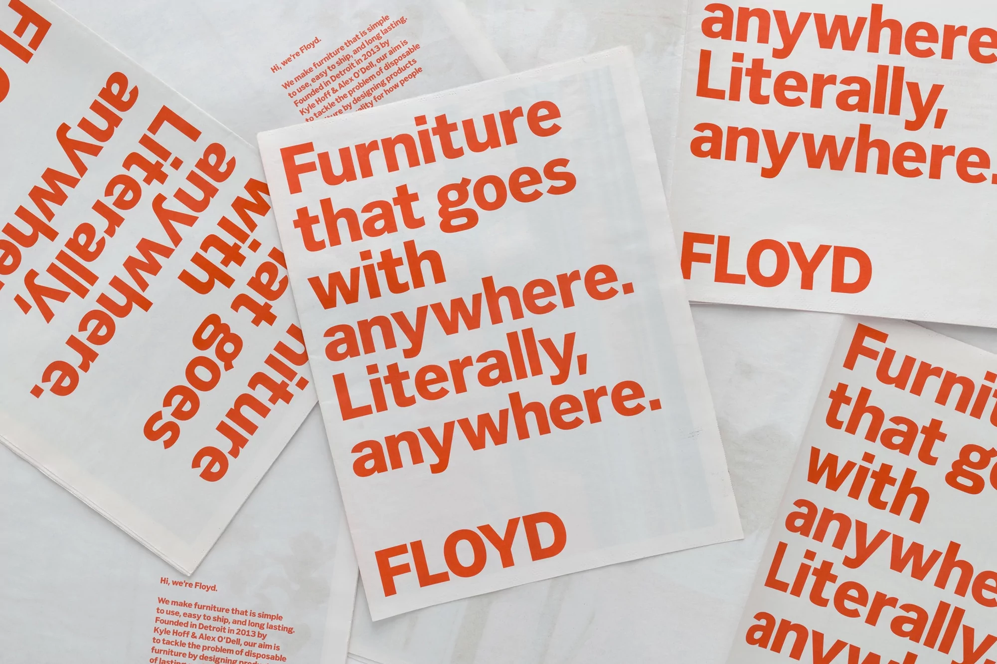 Promotional material featuring the word 'Furniture that goes with anywhere. Literally, anywhere. FLOYD' printed in coral color on white.
