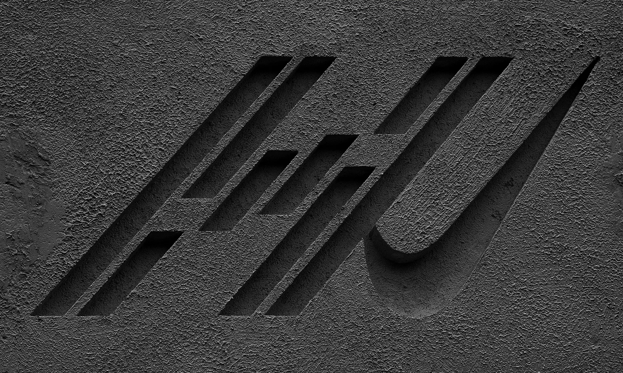 Abstract dark grey stone texture with carved linear design elements and recessed areas creating a geometric pattern.