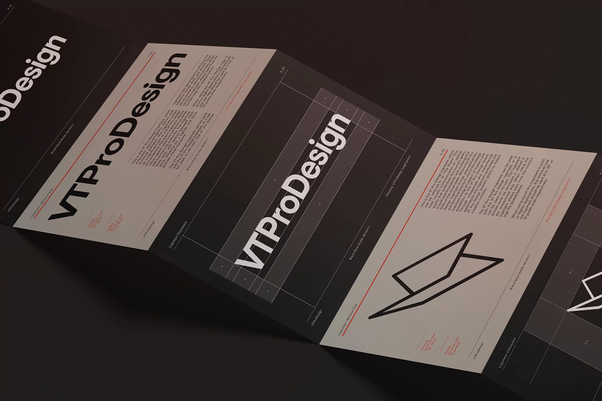 Folded VTPDesign brochure with black and white text and geometric shapes, showcasing layout and branding on a dark surface.
