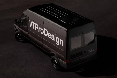 High-angle view of a black cargo van featuring VT Pro Design branding on the side panel parked against a dark ground.