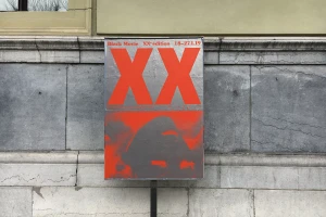 Red and silver festival poster featuring large XX typography mounted on an ornate stone building exterior wall