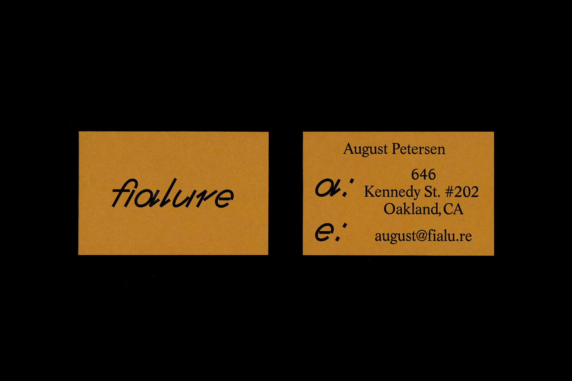 Two business cards with company name 'fialure', contact info: August Petersen, address, email. Brown cards, black background.