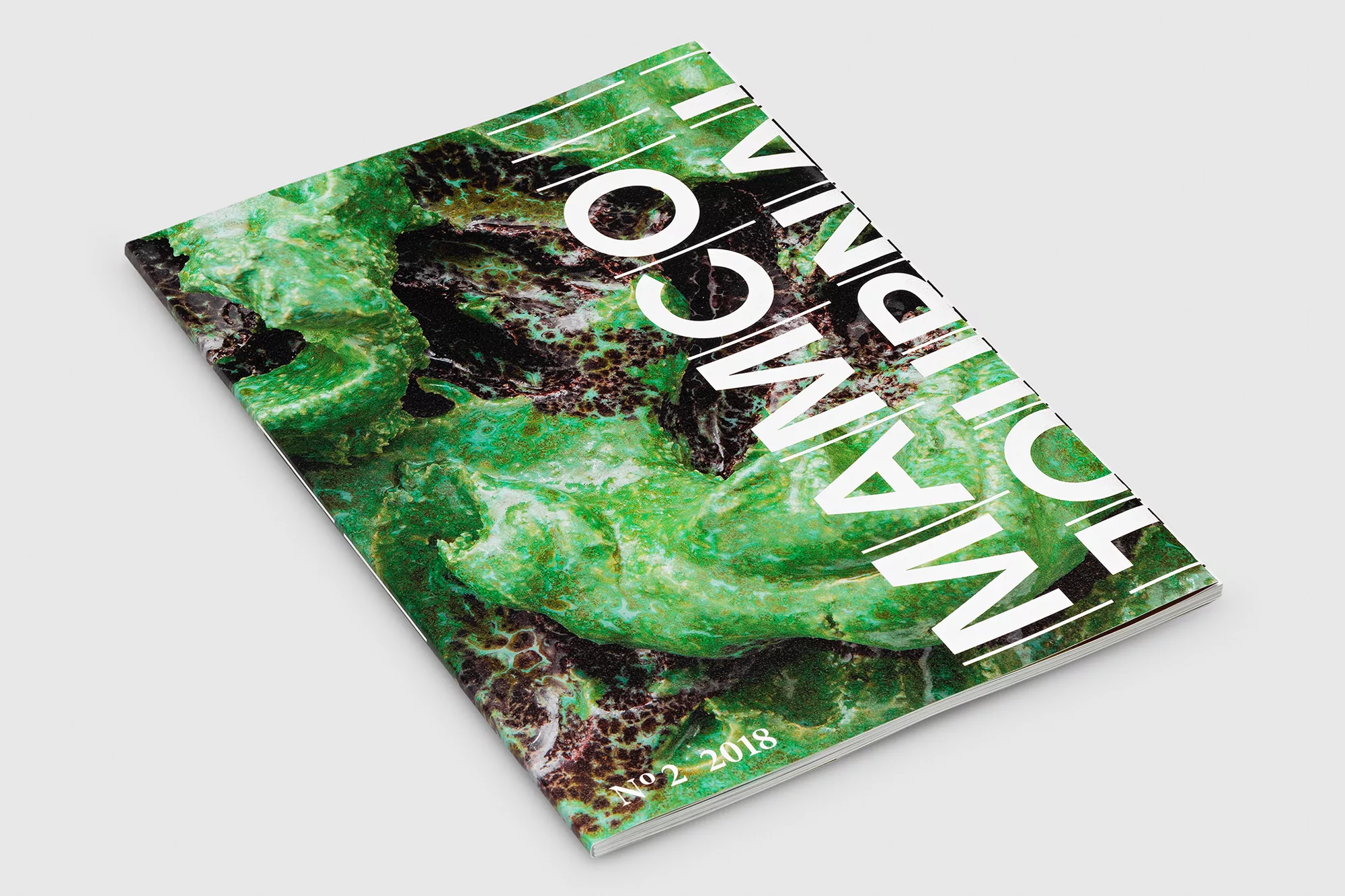 Magazine cover featuring a green and brown abstract textured design with the white text MANGO Journal No. 2 2018.