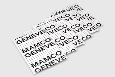 Stacked white printed paper sheets with bold black typography reading Mamco Geneve against a white background